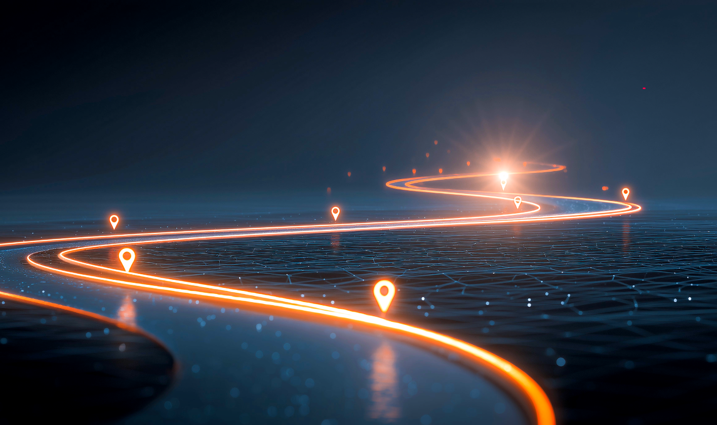 A long-exposure view of a modern highway at night with glowing blue digital data paths and connectivity beacons stretching toward the horizon, symbolizing a global IoT network.